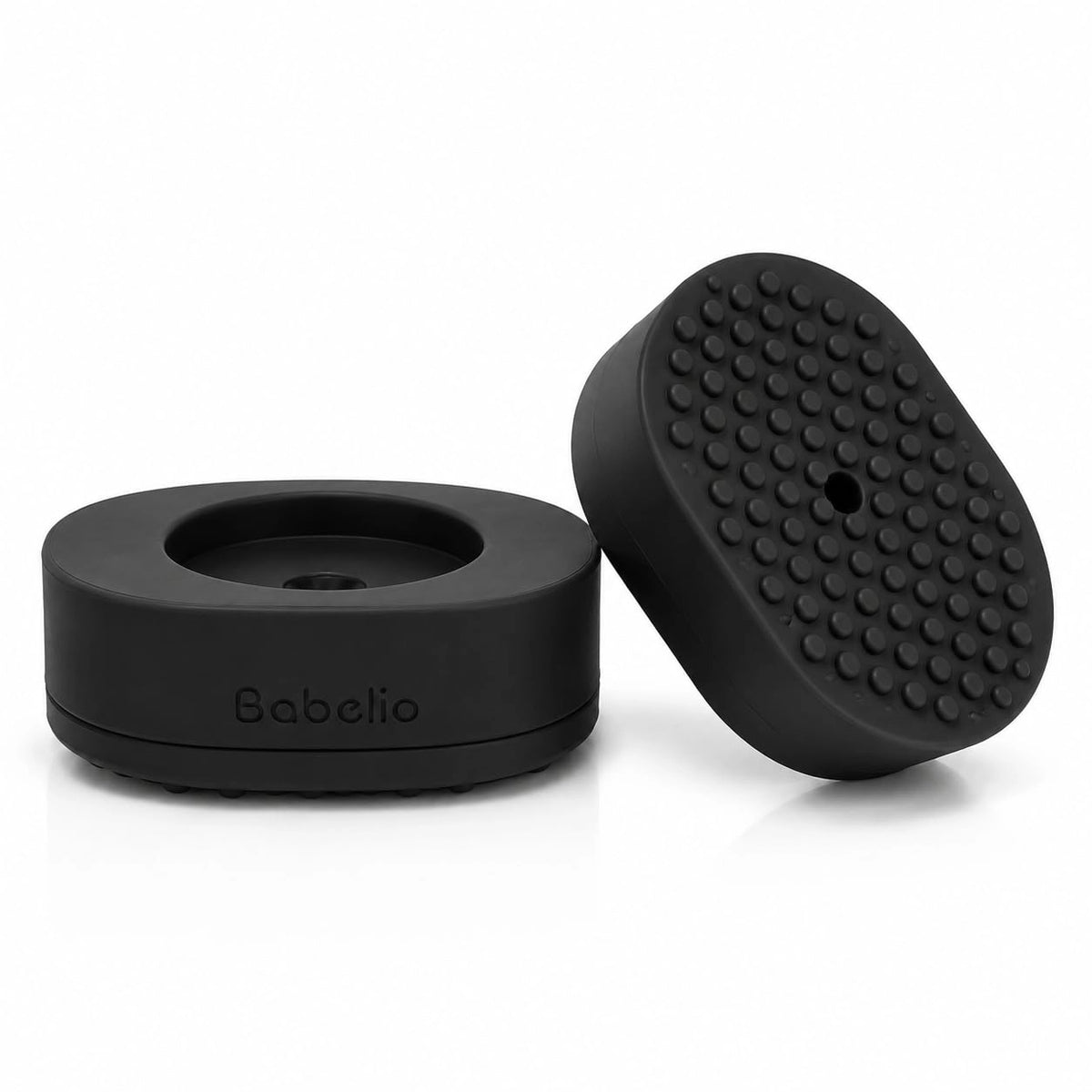 Two black silicone accessories for a personal massager, shown on a clean white background. One piece is a flat circular base with the debossed brand name 'Babelio', and the other is an oval-shaped piece with a raised, textured nodule surface.#Color_Black