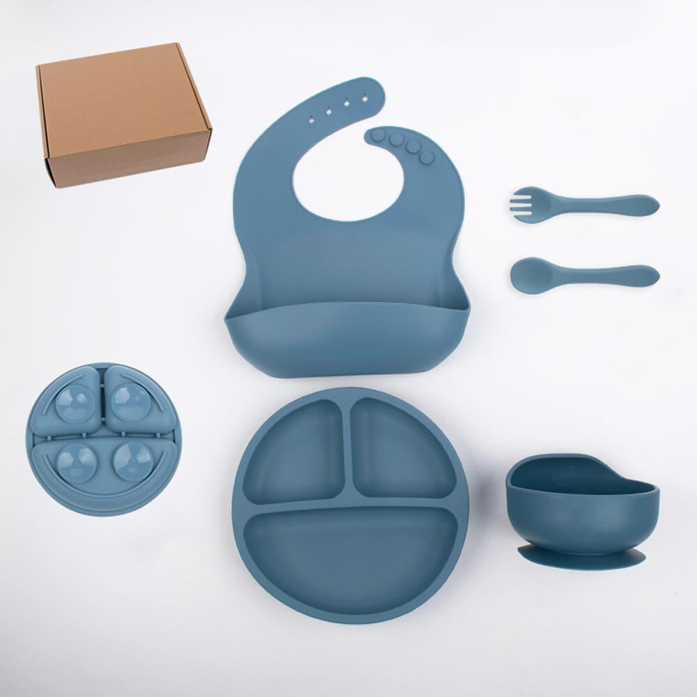 Babelio silicone baby feeding set with bib, plates, bowl, spoon, and fork on white background.