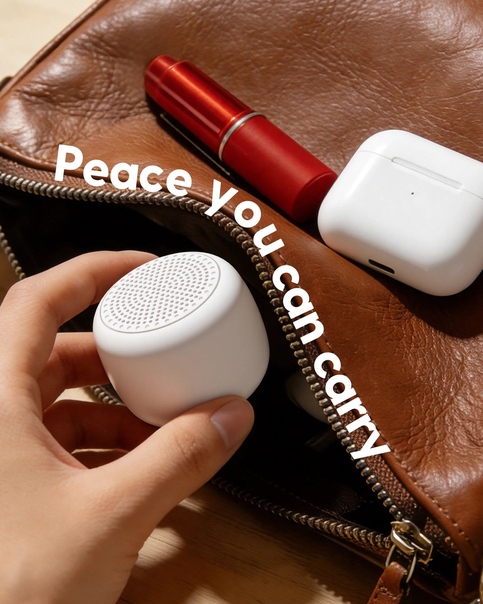 Babelio white noise machine for babies, compact and portable, placed with bag on wooden table