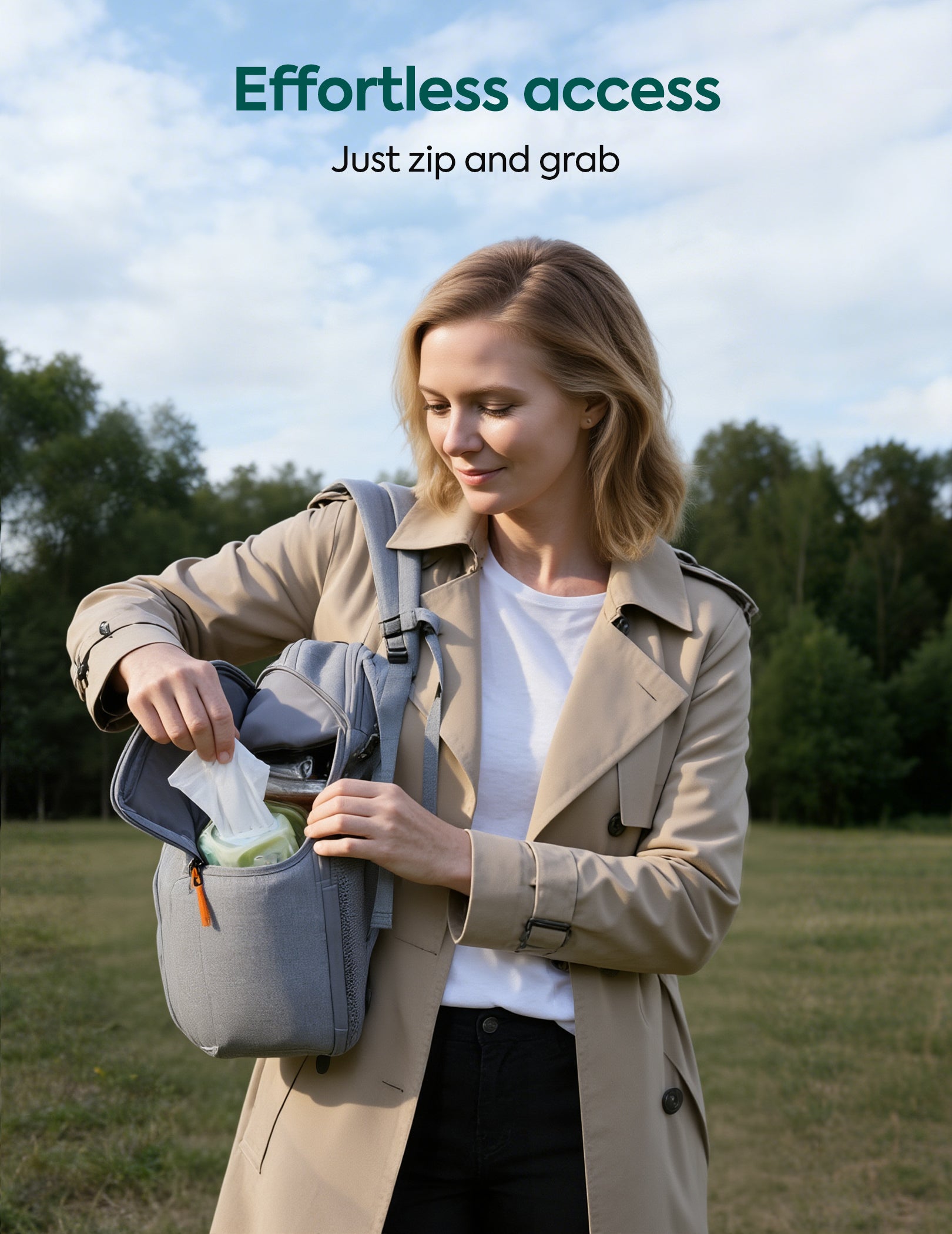 Woman in a beige coat opening a gray bag outdoors with 'Effortless Access' text.#Color_Grey
