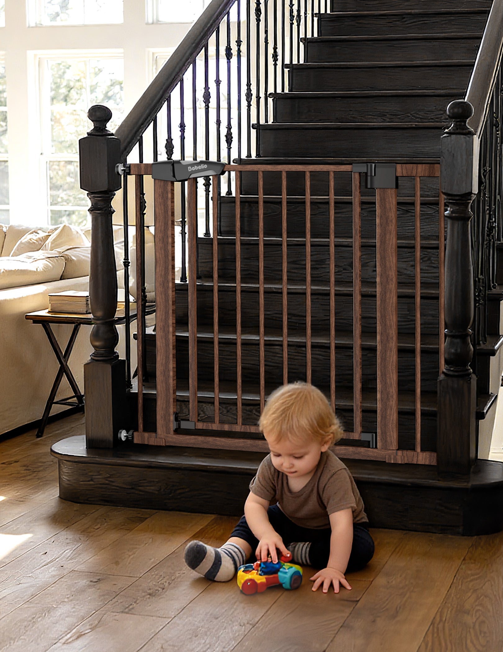 Child playing on a wooden floor with a baby gate in front of a staircase.  #Color_Brown Wood Pattern