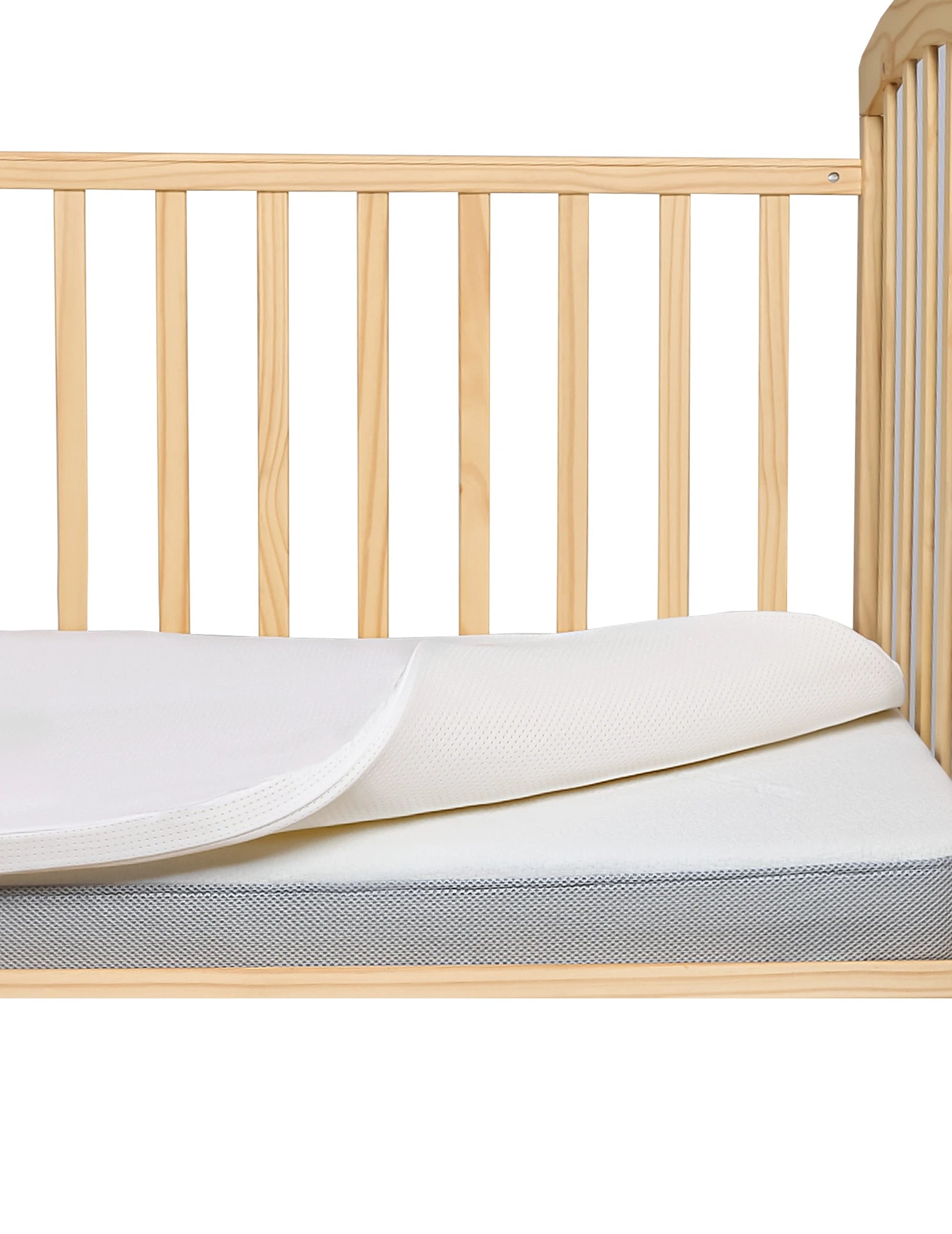 Babelio crib mattress in wooden crib, nursery bedding, breathable cover visible