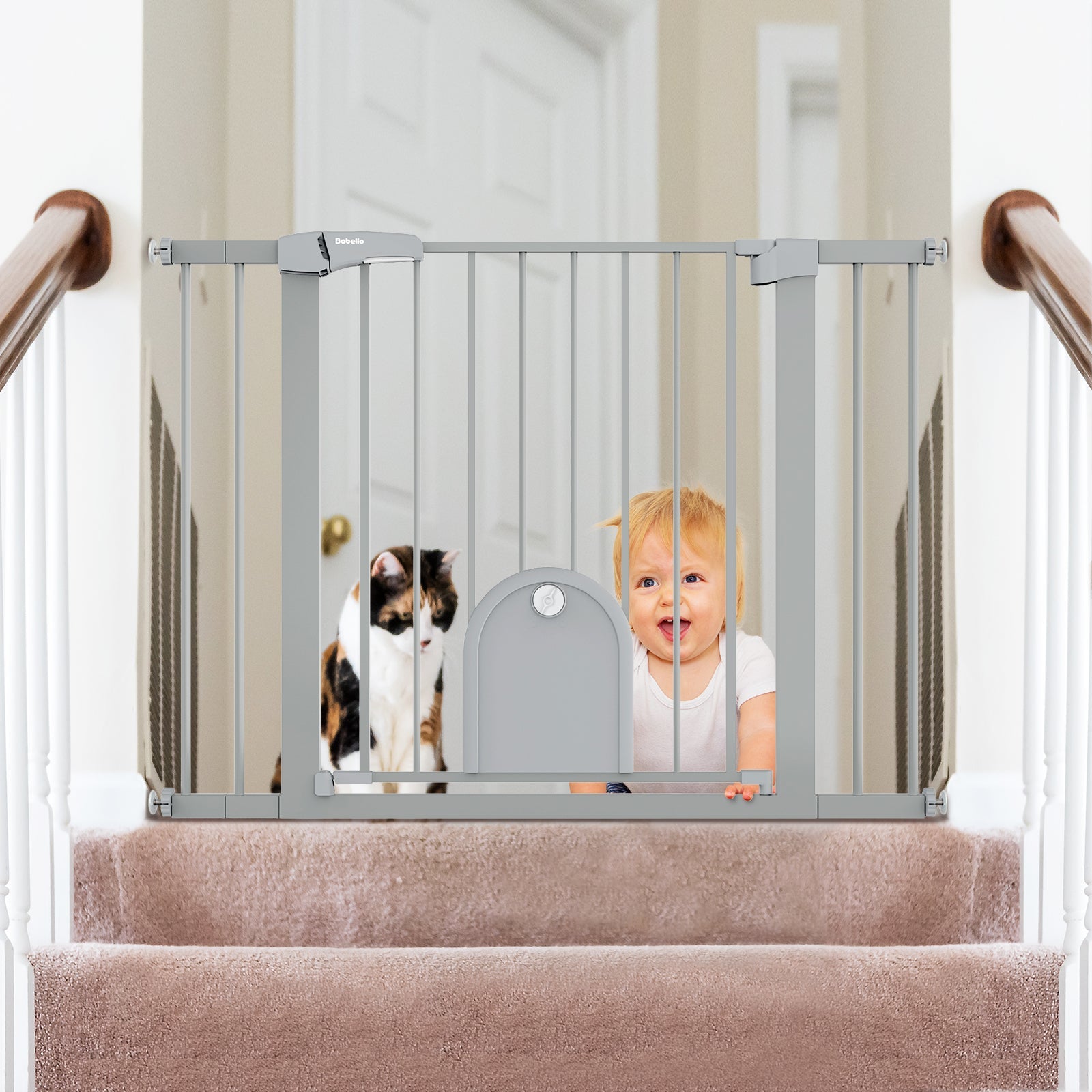 Babelio baby safety gate with lockable pet door installed on staircase, baby and cat behind gate