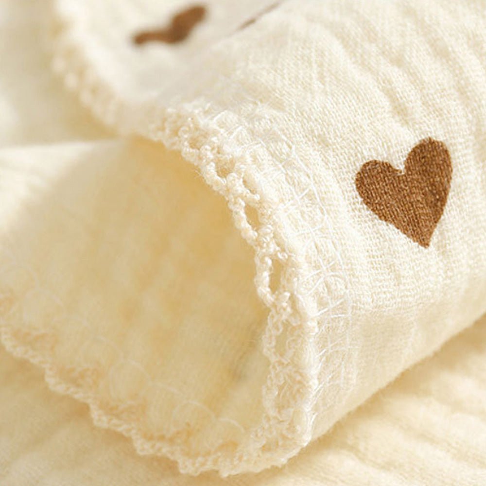 Babelio soft cotton muslin baby bib with heart pattern, close-up showing fabric texture