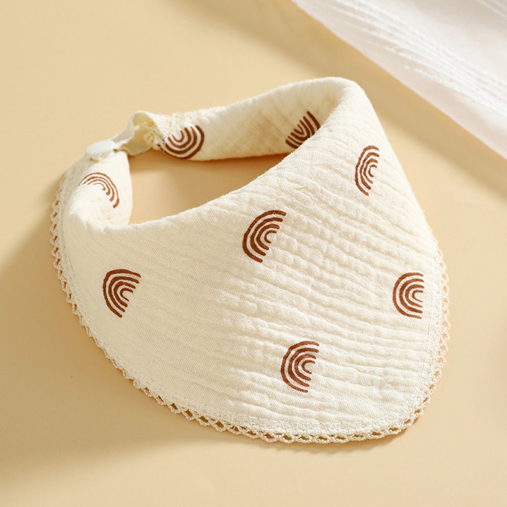 Babelio cream cotton muslin baby bib with brown rainbow pattern on a neutral background