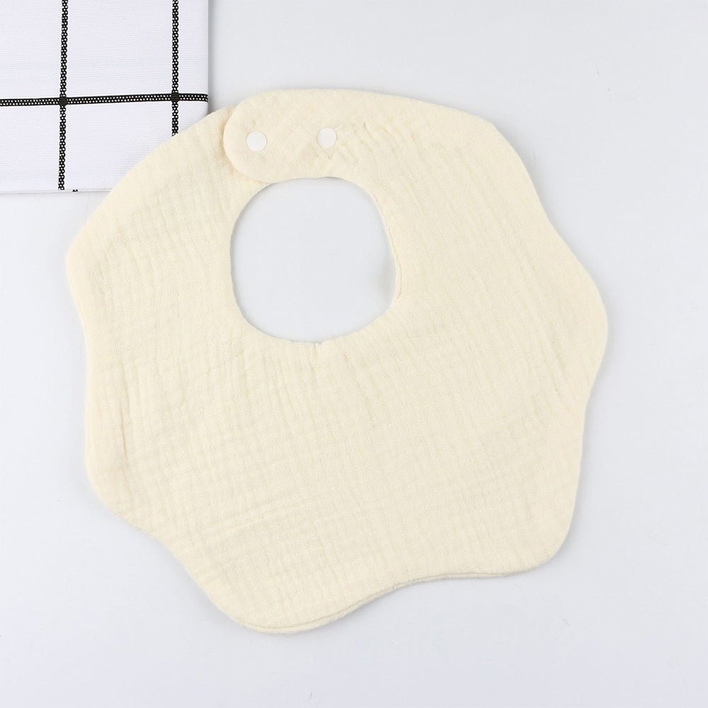 Babelio cream solid color baby bib with snap buttons on a white background