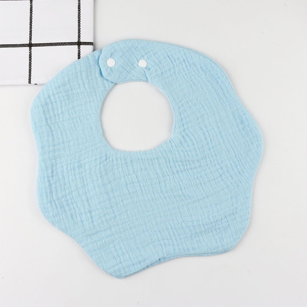 Babelio light blue solid color baby bib with snap buttons on a white surface