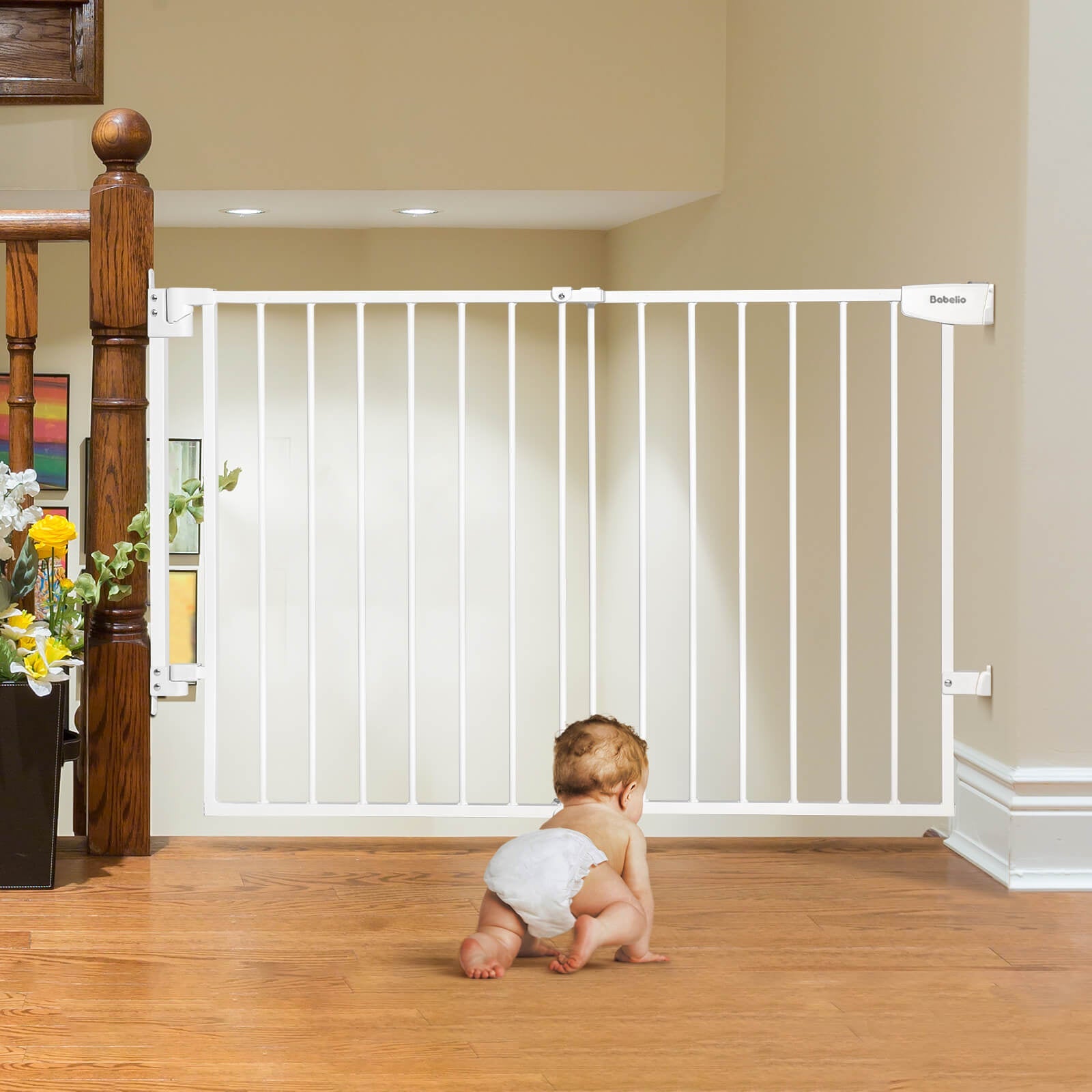 Babelio baby safety gate installed at staircase with baby crawling on hardwood floor